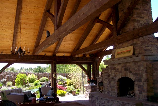 Showing the large fire place inside the timber frame Outdoor kitchen